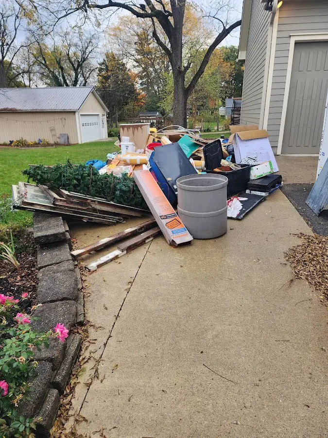 Dumpster being loaded with debris for Estate Cleanout Dumpster Rental in Hansville